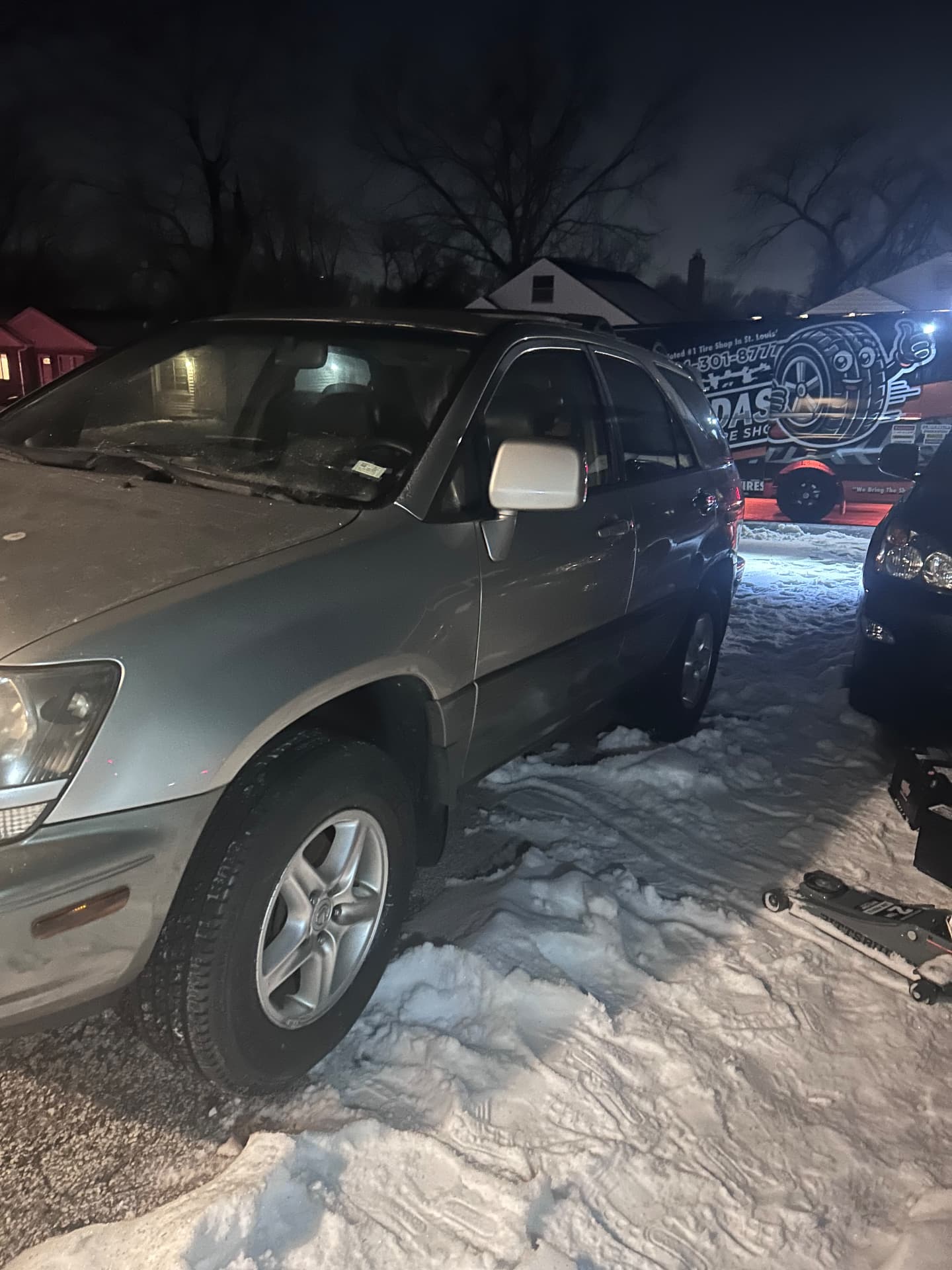 Tire Dash van behind a car on a snowy night