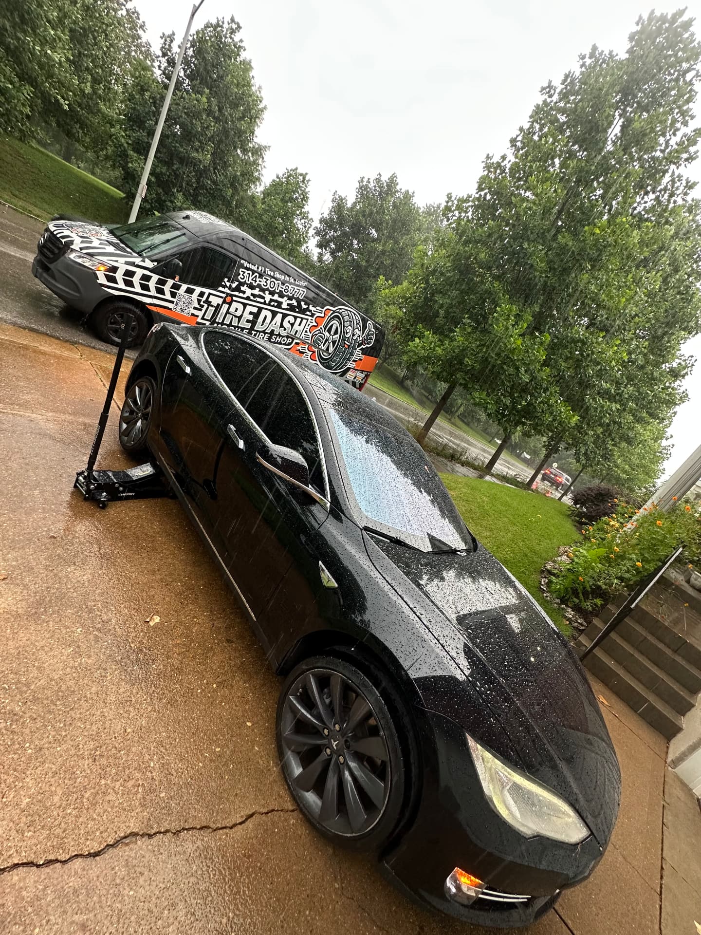Tire Dash van behind a car during rainy-weather service